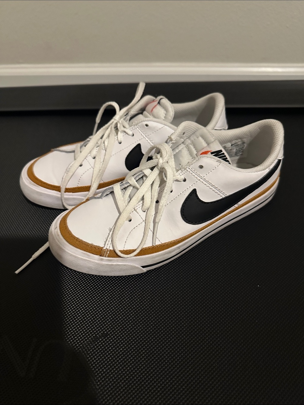 Nike Low-Top White Sneakers with Black Swoosh and Brown Accent
